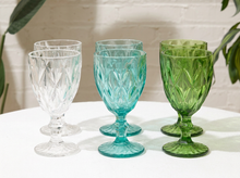 Load image into Gallery viewer, Set of six vintage faceted glass goblets in aqua blue, clear, and olive green with geometric diamond patterns and footed bases

