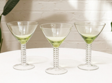 Load image into Gallery viewer, Set of three vintage cocktail glasses with pale green flared bowls, clear spiral textured stems, and round glass bases

