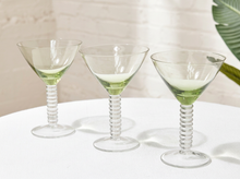 Load image into Gallery viewer, Three clear stemmed cocktail glasses with a pale green tint at the bowl and twisted ribbed stems, arranged on a white table against a softly lit neutral background.
