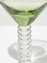 Load image into Gallery viewer, Close-up of a clear glass cocktail glass with a ribbed spiral stem and a pale green liquid inside, photographed on a white background.
