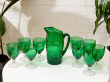 Load image into Gallery viewer, Vintage emerald green glassware set with green goblets on clear textured pedestal stems and coordinating handled green glass pitcher
