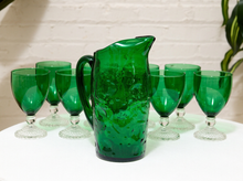 Load image into Gallery viewer, Vintage emerald green glassware set with green goblets on clear textured pedestal stems and coordinating handled green glass pitcher
