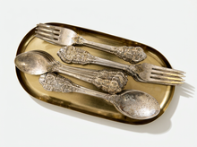 Load image into Gallery viewer, Antique F.B. Rogers Silver Co. silver-plated flatware set with ornate floral scrollwork handles, including forks and spoons with aged patina
