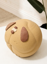 Load image into Gallery viewer, Vintage handmade dog piggy bank with round tan body, large brown floppy ears, dimensional eyes, and playful sculptural details
