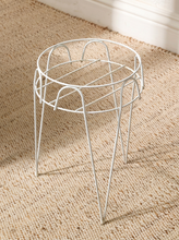 Load image into Gallery viewer, Vintage white painted metal plant stand with open circular wire frame, curved decorative supports, and four slender legs
