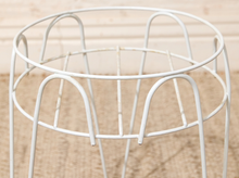 Load image into Gallery viewer, Close-up of the white metal plant stand's circular upper frame and curved wire supports.
