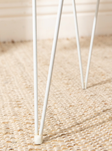 Load image into Gallery viewer, Vintage white painted metal plant stand with open circular wire frame, curved decorative supports, and four slender legs
