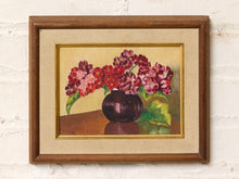 Load image into Gallery viewer, Vintage framed floral still life painting depicting red, pink, and burgundy flowers in a dark rounded vase, with green leaves and a wood frame featuring a textured border and gold trim
