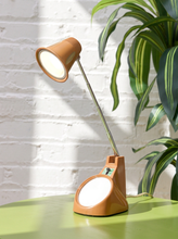 Load image into Gallery viewer, Vintage 1970s orange Space Age desk lamp with chrome adjustable stem, flared shade and circular mirror built into the base.
