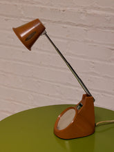 Load image into Gallery viewer, Vintage 1970s orange Space Age desk lamp with chrome adjustable stem, flared shade and circular mirror built into the base.
