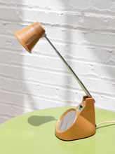 Load image into Gallery viewer, Vintage 1970s orange Space Age desk lamp with chrome adjustable stem, flared shade and circular mirror built into the base.
