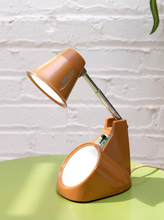 Load image into Gallery viewer, Vintage 1970s orange Space Age desk lamp with chrome adjustable stem, flared shade and circular mirror built into the base.
