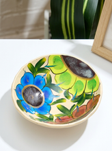 Load image into Gallery viewer, Hand-painted ceramic bowl with large blue and red flowers, chartreuse accents, green leaves, and warm cream background
