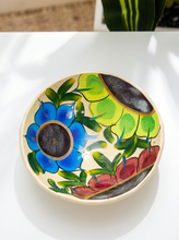Load image into Gallery viewer, Hand-painted ceramic bowl with large blue and red flowers, chartreuse accents, green leaves, and warm cream background
