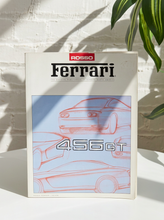 Load image into Gallery viewer, Vintage Rosso Ferrari official magazine featuring illustrated Ferrari 456 GT sports cars and raised 456 GT lettering on the cover
