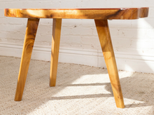 Load image into Gallery viewer, Vintage live edge wood side table with irregular natural wood tabletop, honey-brown grain, visible knots, and three tapered wooden legs
