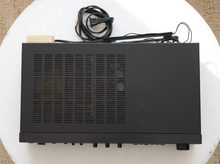 Load image into Gallery viewer, Vintage black Optimus AM/FM stereo receiver with rectangular digital tuner display, large volume knob, front control buttons, and vented top panel

