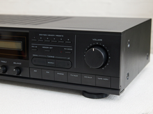 Load image into Gallery viewer, Vintage black Optimus AM/FM stereo receiver with rectangular digital tuner display, large volume knob, front control buttons, and vented top panel

