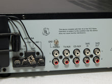 Load image into Gallery viewer, Vintage black Optimus AM/FM stereo receiver with rectangular digital tuner display, large volume knob, front control buttons, and vented top panel

