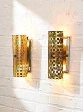 Load image into Gallery viewer, Pair of vintage 1960s metal wall sconces with curved half-cylinder shades, repeating geometric cutout patterns, and rectangular wall mounts
