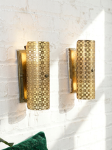 Load image into Gallery viewer, Pair of vintage 1960s metal wall sconces with curved half-cylinder shades, repeating geometric cutout patterns, and rectangular wall mounts
