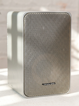 Load image into Gallery viewer, Pair of vintage silver-gray bookshelf stereo speakers with perforated metal front grilles, softly rounded rectangular cabinets, and attached speaker wires

