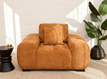 Load image into Gallery viewer, Felipe modern lounge chair in warm terracotta textured upholstery with deep channel-tufted seat, oversized padded arms, rounded silhouette, and coordinating cushions
