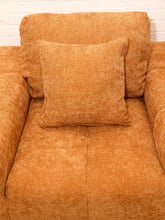 Load image into Gallery viewer, Felipe modern lounge chair in warm terracotta textured upholstery with deep channel-tufted seat, oversized padded arms, rounded silhouette, and coordinating cushions
