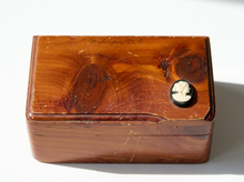 Load image into Gallery viewer, A vintage rectangular wooden keepsake box with a glossy reddish-brown wood grain finish, featuring a small carved ivory cameo profile on the front right and faint 'Washington D.C.
