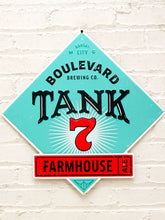 Load image into Gallery viewer, Vintage-style Boulevard Brewing Co. Tank 7 sign mounted on a white painted brick wall.
