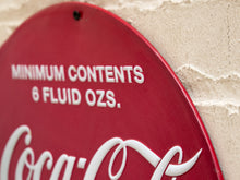 Load image into Gallery viewer, Vintage Coca-Cola advertising metal sign shaped like an oversized red bottle cap with scalloped edges, white Coca-Cola script, and Minimum Contents 6 Fluid Ozs lettering
