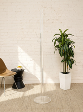 Load image into Gallery viewer, Vintage freestanding clear Lucite coat rack featuring a tall transparent cylindrical column, curved transparent hooks at different heights, and a round clear base.
