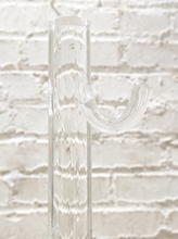 Load image into Gallery viewer, Vintage freestanding clear Lucite coat rack featuring a tall transparent cylindrical column, curved transparent hooks at different heights, and a round clear base.
