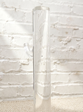 Load image into Gallery viewer, Vintage freestanding clear Lucite coat rack featuring a tall transparent cylindrical column, curved transparent hooks at different heights, and a round clear base.
