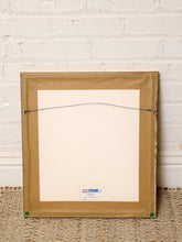 Load image into Gallery viewer, The back of a square picture frame made of light brown cardboard, with a wire hanger across the top and a small 'ART FRAME' label at the bottom, leaning against a white brick wall on a woven rug.
