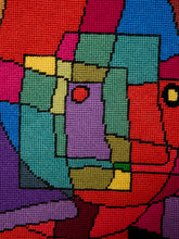 Load image into Gallery viewer, Close-up of a colorful geometric needlepoint canvas with abstract shapes in red, blue, green, purple, pink, yellow, and black.
