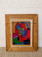 Load image into Gallery viewer, A framed abstract geometric painting with a rustic light brown wooden frame, leaning against a white brick wall on a beige woven rug.
