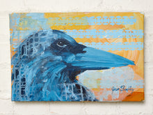 Load image into Gallery viewer, Contemporary raven painting by Jean Bradley featuring a dark blue bird in profile with a long pointed beak, textured navy feathers, and a golden yellow and pale blue geometric patterned background.
