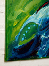 Load image into Gallery viewer, Abstract canvas painting featuring expressive brushstrokes of green, blue, and white, with a textured white brick wall visible behind the canvas.
