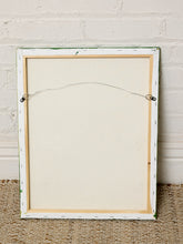 Load image into Gallery viewer, The back of a rectangular framed canvas print, showing the off-white fabric surface, wire hanger, and wooden backing, leaning against a white brick wall on a woven rug.
