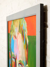 Load image into Gallery viewer, A framed abstract portrait painting hanging on a white brick wall. The artwork features a stylized face with bright orange, green, blue, pink, and yellow brushstrokes, enclosed in a gray frame.
