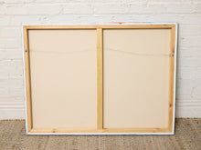 Load image into Gallery viewer, The back view of a wooden double-hung canvas print, showing the beige canvas panels, natural wood frame, and hanging wires, set against a white brick wall and burlap floor.
