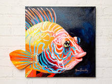 Load image into Gallery viewer, Contemporary tropical fish painting by Jean Bradley featuring a vibrant orange, turquoise, and coral fish with intricate swirling patterns, prominent eye, and fins extending beyond the dark navy canvas.
