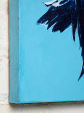 Load image into Gallery viewer, Close-up of a canvas painting showing a bright turquoise blue background with dark navy and black brushstrokes, photographed against a white painted brick wall.
