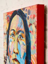 Load image into Gallery viewer, Image 6 of 8: A close-up of a colorful canvas wall art print showing an abstract portrait of a woman's face, mounted on a white brick wall.
