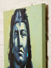 Load image into Gallery viewer, A square canvas painting of a Native American man's portrait, painted in blue, black, and white tones against a pale yellow-green background, shown hanging on a white brick wall.

