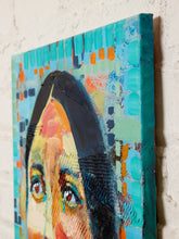Load image into Gallery viewer, A close-up of a textured canvas painting featuring a stylized portrait with turquoise, teal, black, peach, orange, and cream brushstrokes, shown against a white brick wall.
