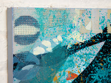 Load image into Gallery viewer, Abstract mixed-media canvas painting featuring textured blue, teal, black, and white elements, photographed against a white brick wall.
