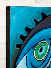 Load image into Gallery viewer, A close-up of a colorful abstract canvas painting featuring a stylized eye with a bright green iris and blue and black details, mounted against a white brick wall.
