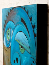 Load image into Gallery viewer, A close-up of a colorful abstract canvas painting depicting a stylized face with bright blue and turquoise tones, green eyes, and black outlines, shown against a white brick wall.

